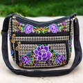 Ethnic embroidered crossbody bag in black with vibrant floral patterns and multi-zipper pockets - Purple Lotus