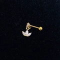 Macro view of gold piercing earring with crown pendant and zircon stones on black velvet - Gold-Crown