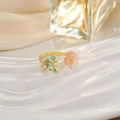 Detail of gold tulip ring featuring pink opal flower and blue zircon stones - Pink Flower Blue White Wings Style (JZ0143)