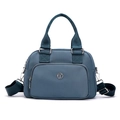 Blue nylon handbag with adjustable shoulder strap and front zipper pocket in studio light - Light Blue