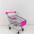 Detailed side view of a pink and silver mini metal shopping cart for desk organization - Peach Pink