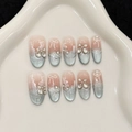 Blaue Cat-Eye Kunstnägel mit weißen Schleifen und Strassblumen im praktischen 10er-Set - XS