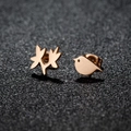 Asymmetric rose gold bird and leaf earrings crafted in polished stainless steel on black surface - Bird & Leaf / Rose Gold