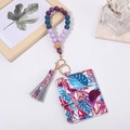 Close-up of tropical leaf pattern card wallet with silicone beaded wristlet and gold hardware - Tropical Leaves