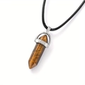 Macro shot of hexagonal tiger eye crystal pendant with silver clasp and black cord - Tiger's Eye