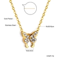 Vue détaillée du pendentif papillon doré avec strass clairs sur une chaîne en acier - Papillon / Acier