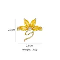 Close-up of a floral brooch with yellow crystals and white zircon set in gold - B753 Golden/Flower Ribbon