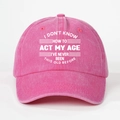Close-up of pink washed cotton baseball cap with white printed I Don't Know How To Act My Age text - One Size / Rose Red