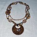 Detail view of multi-layer beaded necklace with leopard print pendant and golden glitter - Ring Pendant (HN8851) / Pink Leopard Pattern