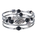 Detail of bohemian multilayer stretch bracelet with black beads and silver metal charms - Black Obsidian