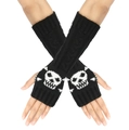 Close-up of black knitted fingerless gloves with white skull pattern on the back - One Size / Black