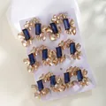 Detailed view of butterfly-themed gold-plated ear cuffs with blue rectangular zircons - 18K Gold Plated Blue Gem Butterfly Ear Cuffs Set