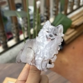 Detail view of Samoyed dog hair claw clip with white pearlescent acetate texture - Fluffy Samoyed