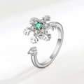 Detail of silver snowflake rotating ring with green gemstone and small white diamonds - White Gold Snowflake Rotating