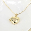 Detailed close-up of golden heart locket necklace featuring a zircon-studded Hamsa hand - Hamsa Hand