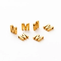 Macro shot of 18K gold plated letter M beads with 1.8mm hole for DIY jewelry making - M / Gold