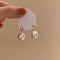 Elegant gold teardrop earrings with large white pearls on a display card - Teardrop Pearl (A2218 Silver)
