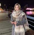 Beige and brown plaid mohair scarf with tassels worn by a model in city night - Striped Khaki