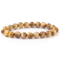Macro shot of natural yellow tiger eye beaded bracelet showing silk luster and cat eye effect - Golden Tiger Eye
