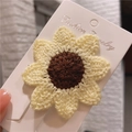 Handmade crochet sunflower hair clip in yellow yarn on jewelry display card - Sunflower