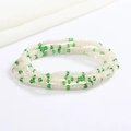 Detail of green and pearl white beaded body chain made of small elastic glass seed beads - Green Pearl White