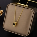 Elegant gold necklace featuring a black enamel barrel pendant with crystal accents - 8937 Golden Black Shell