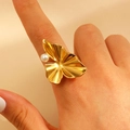 Detail of a golden leaf-shaped ring featuring a textured petal design and a single pearl - Ginkgo Leaf Pearl Shape (11759)