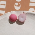 Macro view of pink heart and round resin beads on a white ceramic plate for DIY crafts - Light Red Round