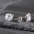 Macro detail of 7mm round cubic zirconia stud earring with 4-claw steel setting on stone - 7mm / Silver
