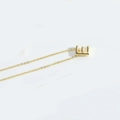Minimalist gold clavicle chain necklace featuring a 3D uppercase letter E pendant - Letter E