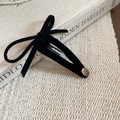 Detail showing black velvet bow hair clip with gold Smile Happy metal charm - Black - Single Bow (BB Clip)