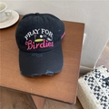 Distressed black baseball cap with Pray for Birdies embroidery on wooden table - Adjustable / Black