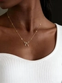 Bohemian gold bow necklace with stone beads and pearl pendant on a model - Gold Bowknot Bead Chain Necklace (G-545)