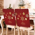 Detail of red Christmas chair covers with gold snowflake patterns on white wooden chairs - Red Gold Snowflake Merry (YTM2-37)