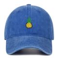 Close-up of embroidered pineapple on a washed blue cotton canvas baseball cap - Dark Blue