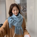 Detailed view of light blue scarf with soft texture and classic fringe ends - Deep Blue