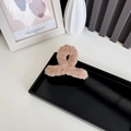 Faux rabbit fur shark hair claw clip in camel brown with a twisted plush knot design - Brown