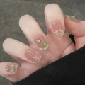 Detail of nude cat eye press-on nails with white 3D flowers and butterfly charms - By1580 Elegant Steps / Glue Type