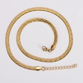 Detail of golden flat snake chain necklace with textured blade pattern and lobster clasp - Gold Color Stripe Polka Dot