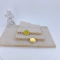 Detail of yellow enamel lemon slice pendants with golden textured back on stone base - Yellow Lemon Slice