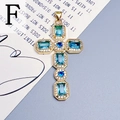 Detailed view of a gold cross pendant with blue zircons and clear crystals on a poetic background - Blue-F