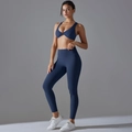 Detail view of the twisted knot sports bra and high-waisted dark blue yoga set leggings - S / Navy Blue