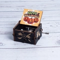 Black wooden Halloween music box featuring a winged eyeball carving and pumpkin art - Hand-cranked Halloween Q
