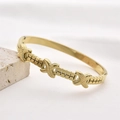 Golden titanium steel bangle with geometric X-shaped relief and crisscross pattern - Gold Geometric Relief