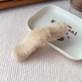 Detail view of plush beige faux fur hair clip on a white decorative tray with soft shadows - Basic Style / Khaki