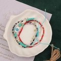Detail of colorful handmade beaded bracelet with evil eye charm in a ceramic dish - Style 21-5pcs Evil Eye Set