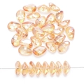 Close-up of 8x17mm peach iridescent glass petal beads with center hole for DIY jewelry - Amber Gold