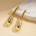 Detailed view of gold teardrop earrings with a mirror finish on marble stone - Gold / Gold