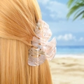 Leaf-shaped hair claw in beige with gold veins and rhinestones shown on model at beach - 9.1cm / Transparent Marble