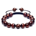 Gros plan sur les perles œil de tigre rouge avec cordon tressé noir réglable et nœud - Diamètre de perle 10mm / Bracelet Oeil de Tigre Rouge